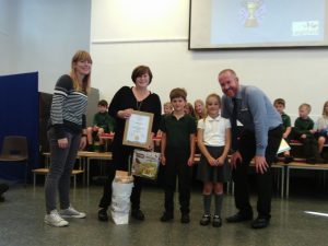 Uppingham in bloom chair presents gold award for best school garden to Leighfield Academy.